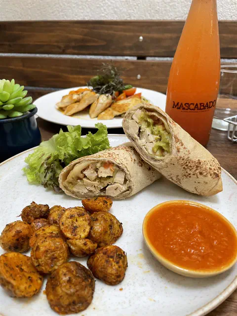 Wraps de pollo con papas criollas y una bebida en botella